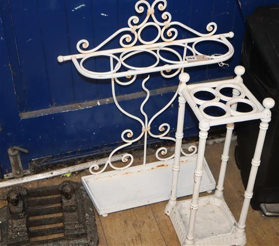 Two painted metal stick stands and a Victorian cast iron boot scraper